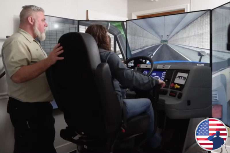 Instructor with a student on the truck driving simulator.